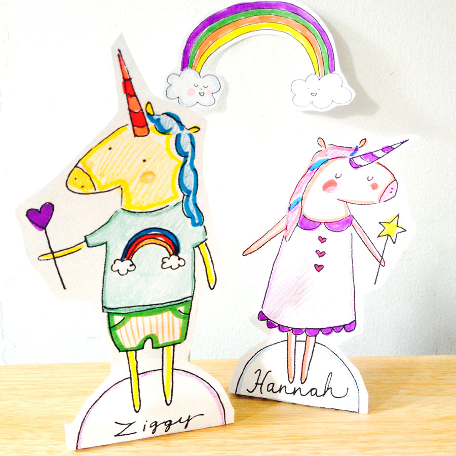 Colored unicorn paper cut outs with a rainbow
