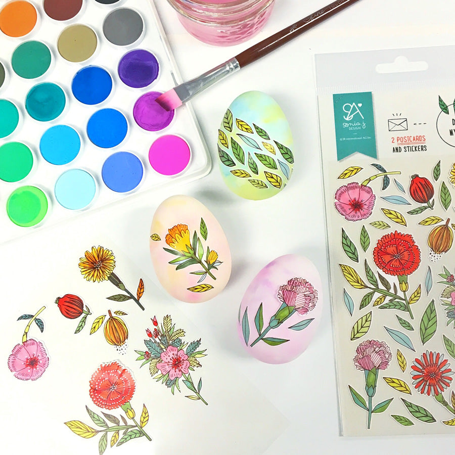 Easter eggs decorated with floral stickers and lil Watercolor paint pods