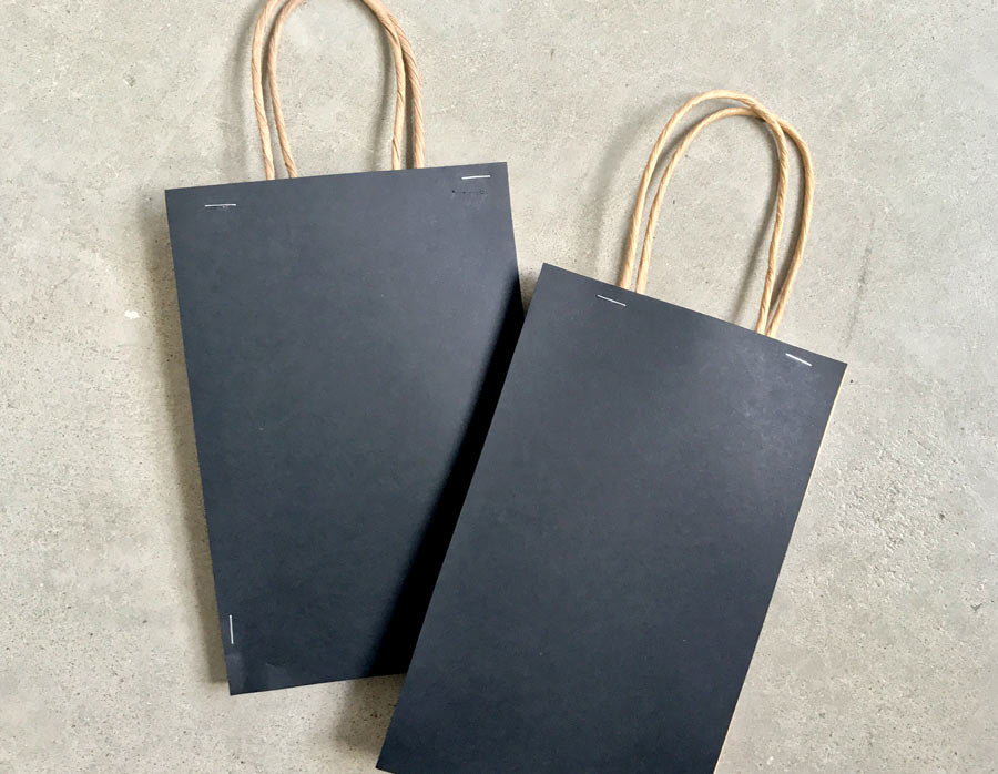 Two do it yourself black paper bags ready for crafting