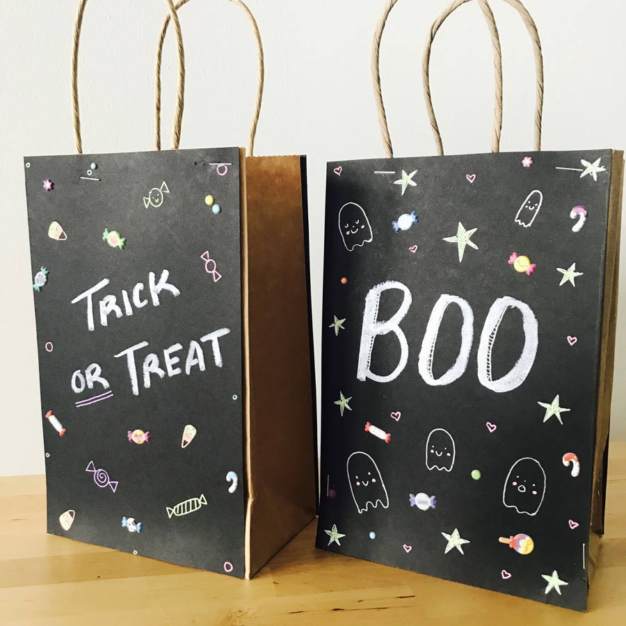 Finished DIY trick or treat bags made with black paper and creative designs