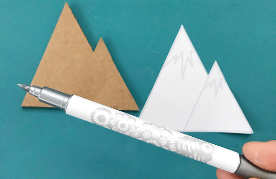 Color Lustre silver marker on a printable paper cutout of mountains