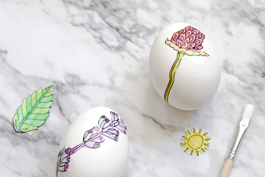 Flowers, sun and plants decoupage decorating on eggs with coloring books
