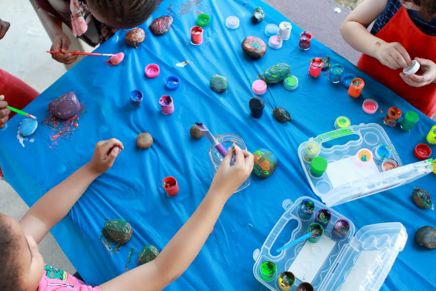 Photo of kids painting rocks with OOLY Paint Pods paint sets