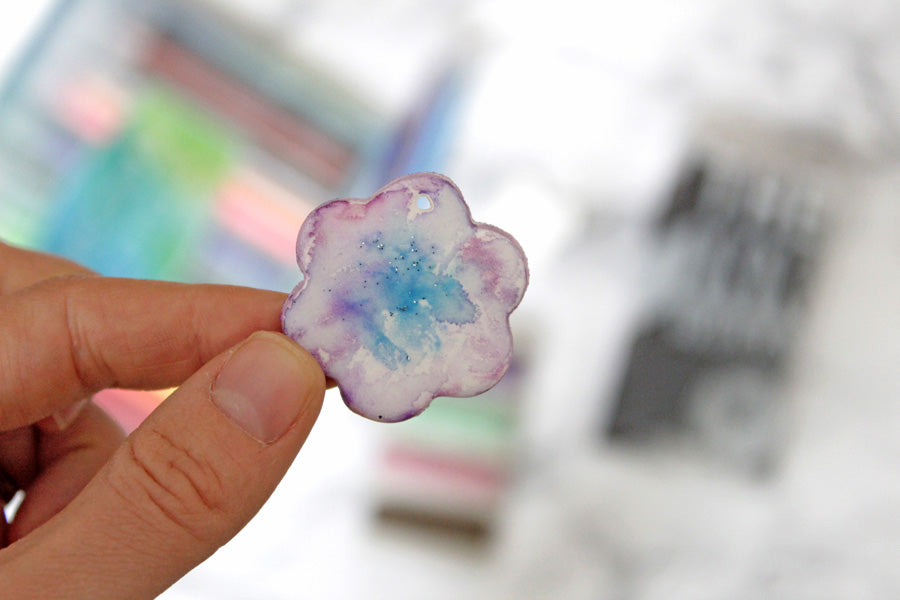 Watercolored clay pendant with purple and blue paint