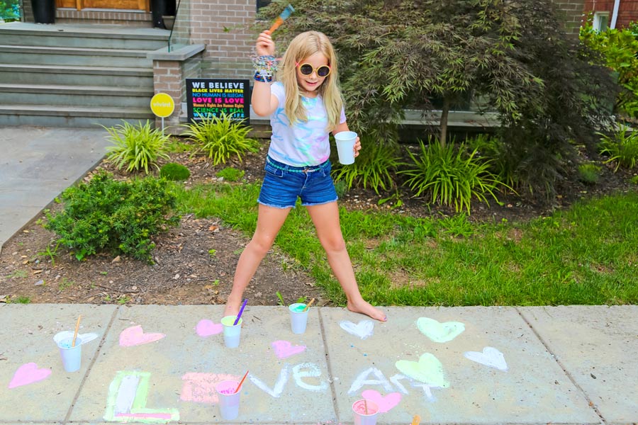 Girl painting with DIY sidewalk chalk paint