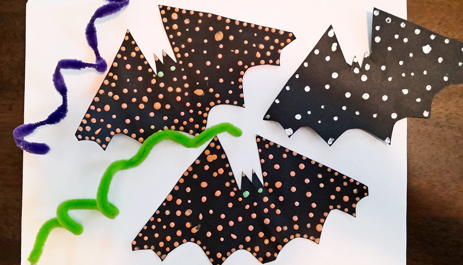 Black paper Halloween bats with orange and white dot paint