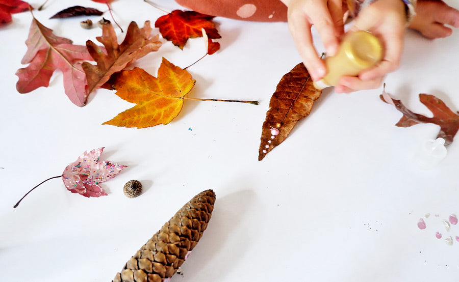 Kid dot painting on fall leaf for fall crafting