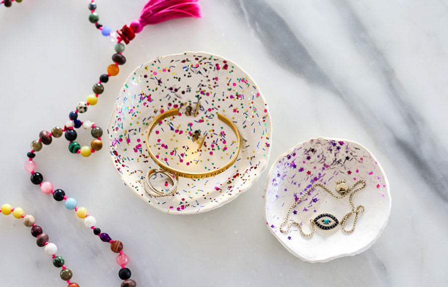 Completed DIY trinket dish with glitter and jewelry