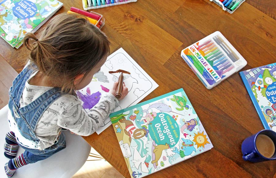 Little girl coloring in OOLY Outrageous Ocean coloring book