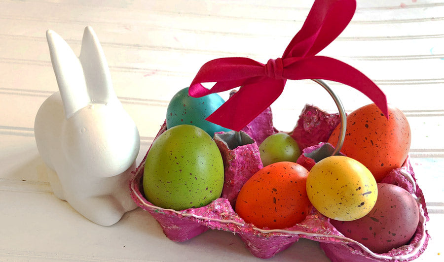 Easter eggs inside DIY Easter basket made with recycled egg carton and poster paint