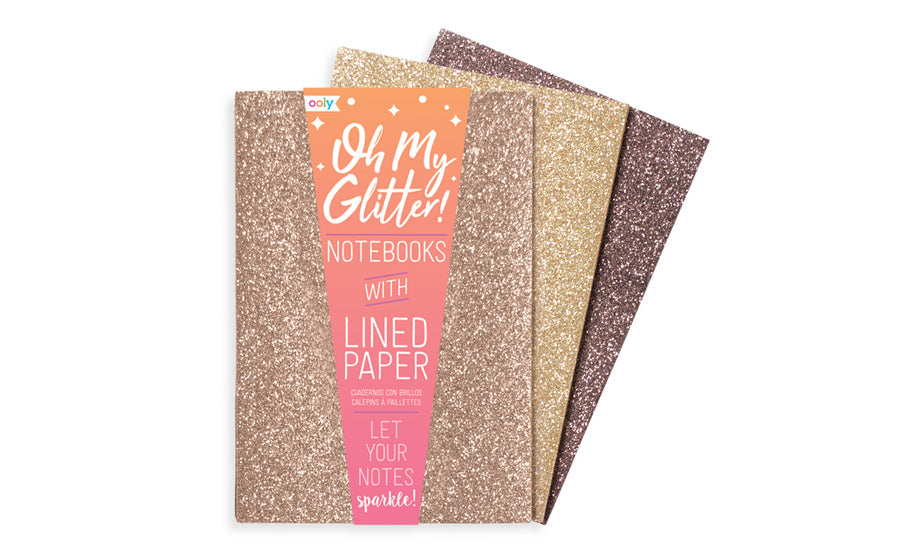 display of three Oh My glitter notebooks in gold