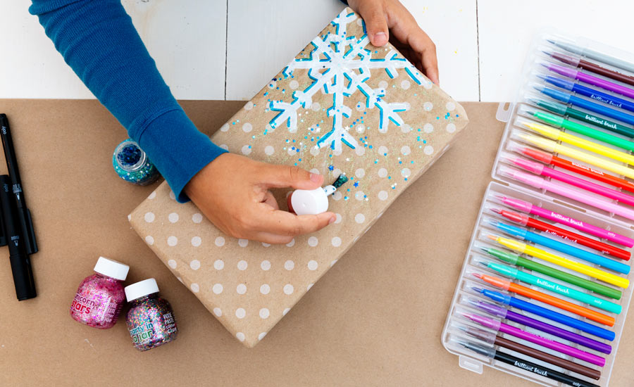 Materials need for DIY Gift Wrap including brush markers, pixie paste and the ink works markers
