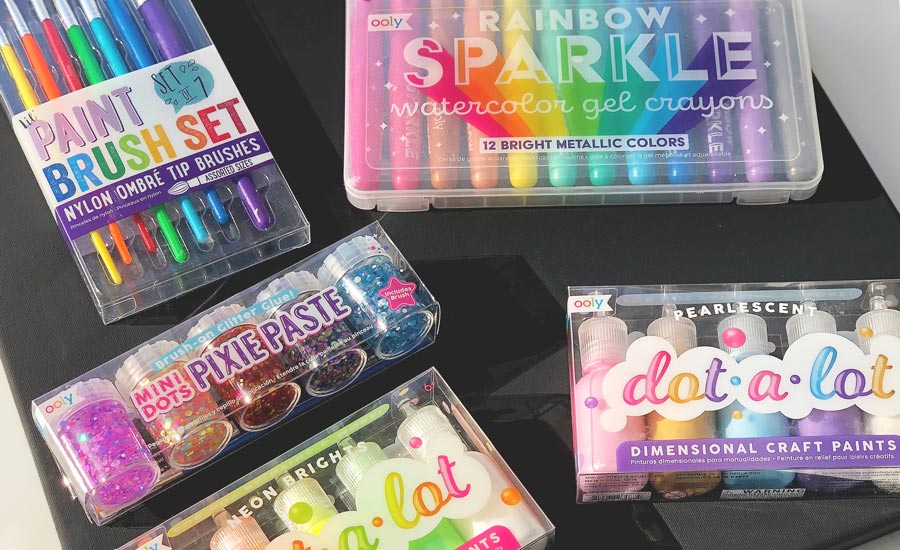 OOLY Supplies needed for a DIY dazzling fireworks scene: lil paint brush set, rainbow sparkle watercolor gel crayons, mini dots pixie paste and dot-a-lot