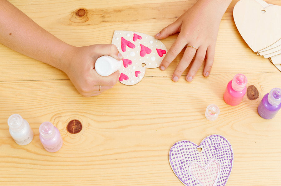 Easy Valentine's Day Craft, Using OOLY dot-a-lot craft paint to decorate the wooden hearts