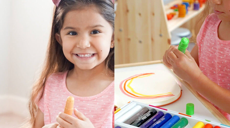smiling brown haired girl holding paint stick and painting a rainbow