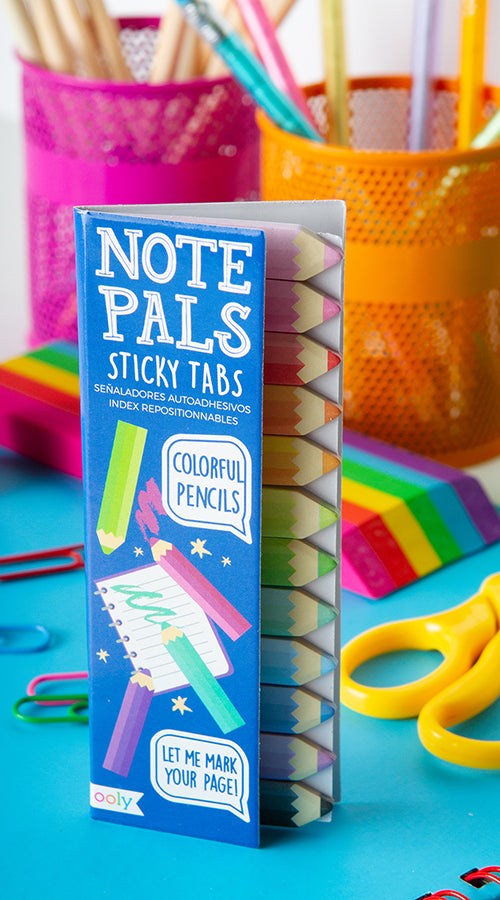 notte pals sticky tabs on blue surface with school supplies in background
