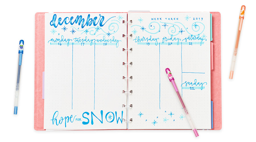 december planner pages with colorful pens on white background