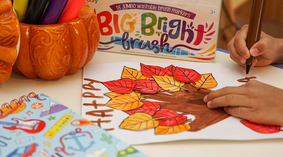 fall tree on white paper surrounded by school supplies