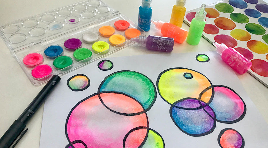 colorful bubbles on white surface with art supplies