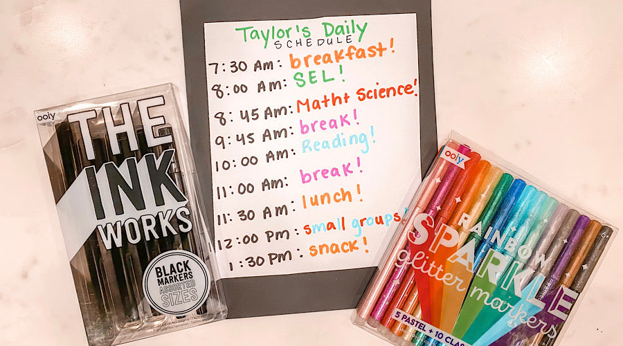 black and rainbow markers with school schedule on white surface
