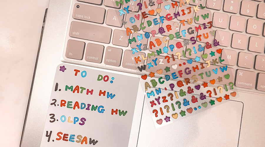 paper note on laptop with letter stickers