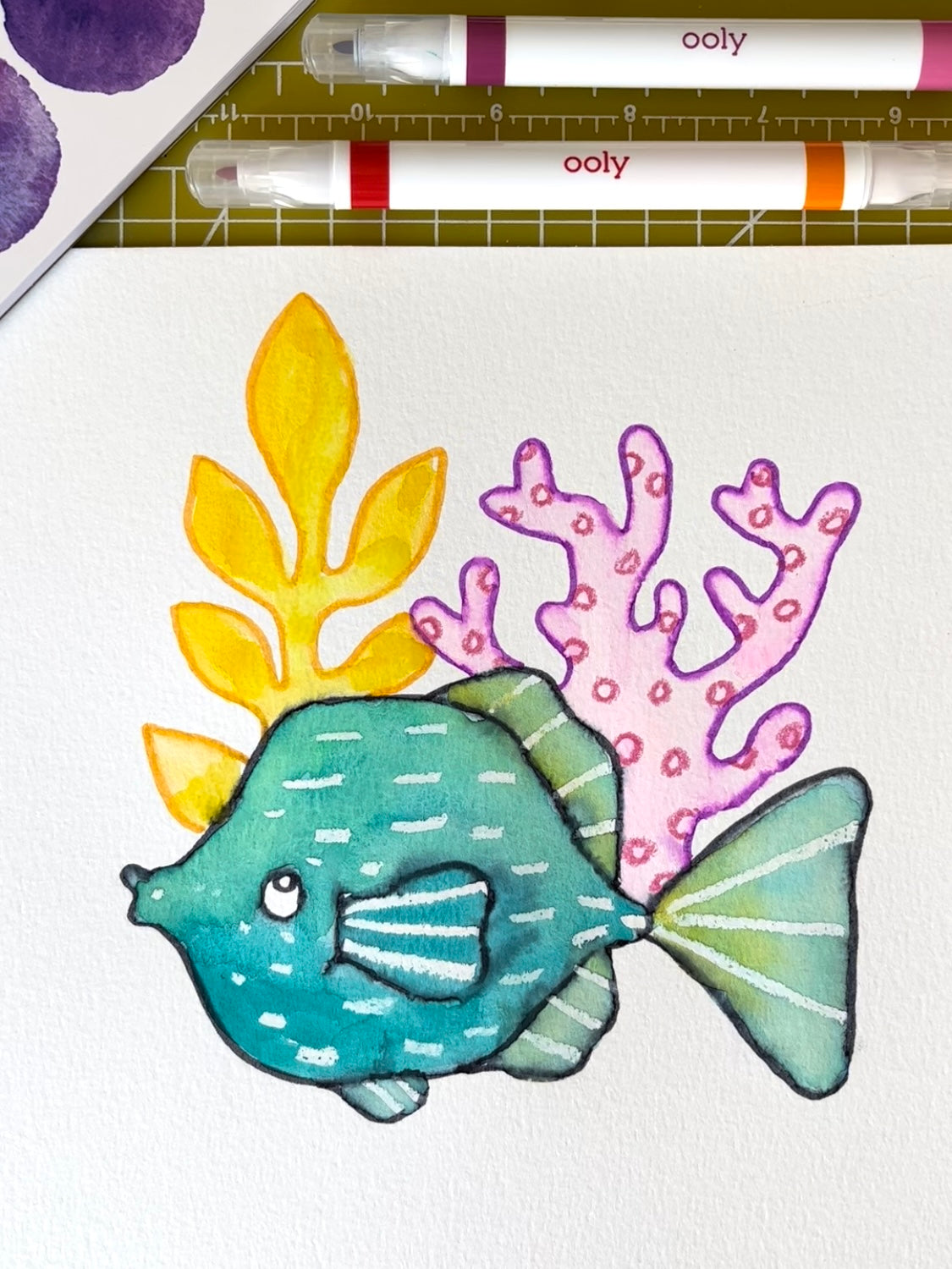 Fish with colors and markers on graph table and white paper