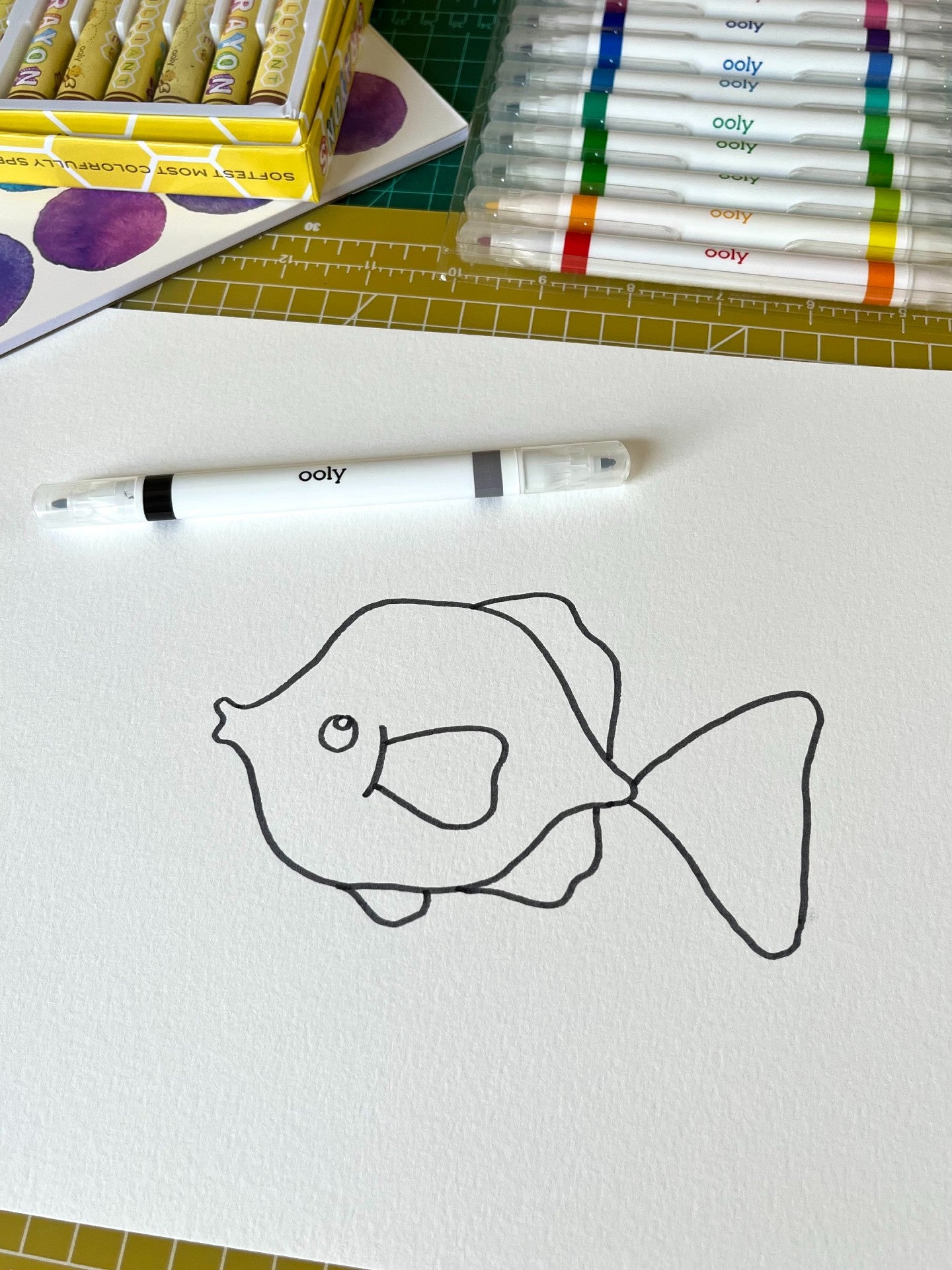 Outline of fish on white paper with black marker