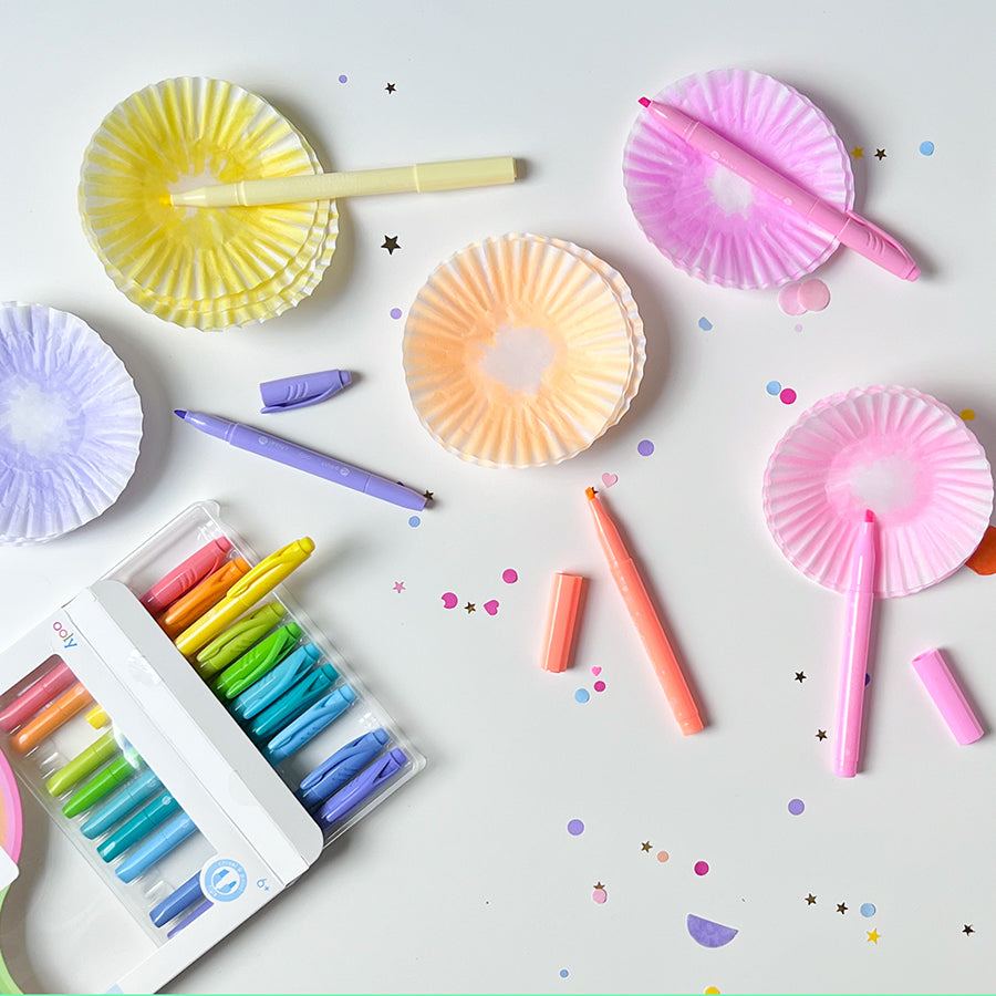 Colorful cupcake liners with markers on a craft table