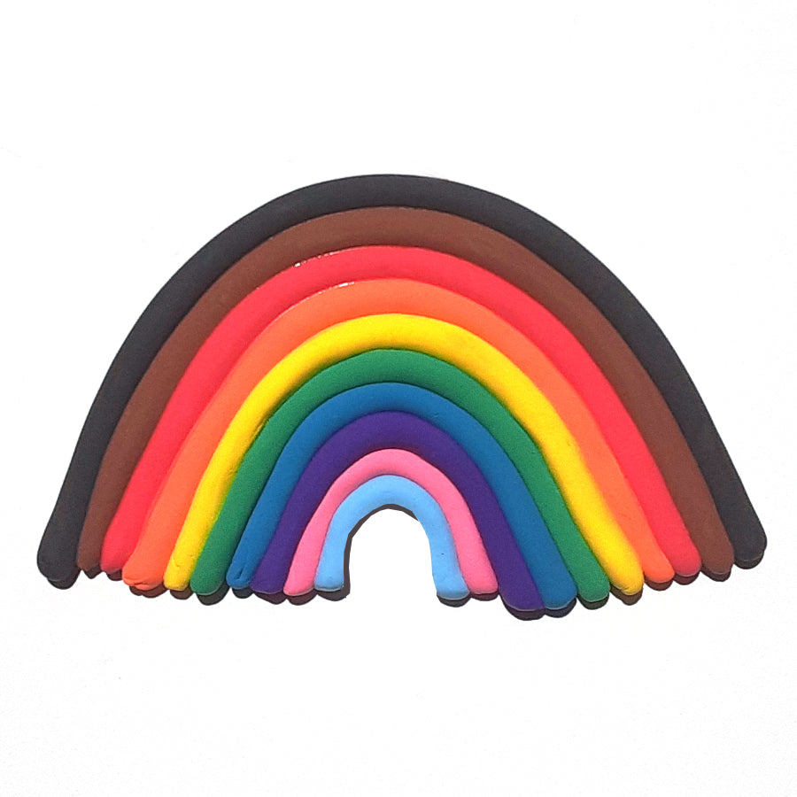 Colorful dry clay rolled out and put into the shape of a rainbow