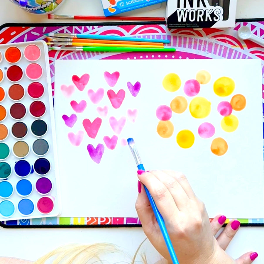 Painting watercolor hearts and circles on watercolor paper