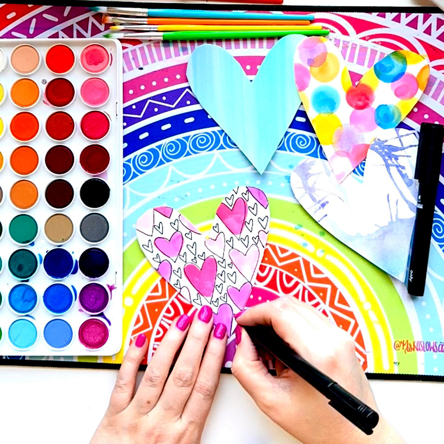 Outlining heart pattern with Ink Works marker over watercolor paint craft